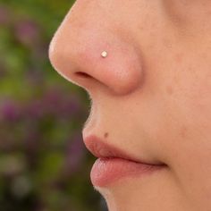 a woman's nose with small white dots on the tip of her nose and bottom lip