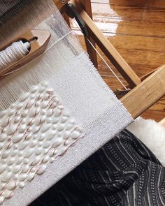 a close up of a weaving machine on a wooden floor