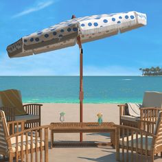 an umbrella and some chairs on the beach