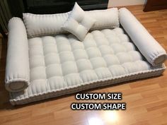 an inflatable bed is on the floor next to a fire place with pillows