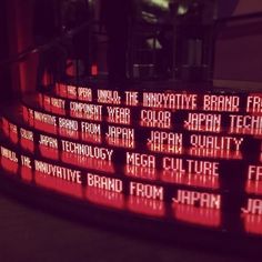 the words are written in different languages on a large display screen that is lit up with red light