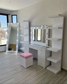 a room with a vanity, mirror and stool next to a large window that looks out onto the city