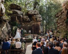 a couple getting married in front of an outdoor wedding ceremony at a stone clifftop