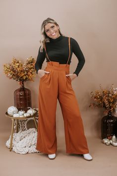 The Setting Trends Suspender Pants in Rust are a trendy and stylish choice for your wardrobe. These suspender pants are perfect for a 30-something mama who loves boutique fashion and wants to make a fashion statement. These pants are a surefire way to set trends and show off your fashion-forward style. Solid Paper Bag High-waist Wide Leg Suspender Pants Wide legs Full length Wide banded high waist Side hidden pockets Made in the USA Inseam: Small 30 in Medium 30.50 in Large 30.75 Rise: Small 15. Tie Shirts, Suspender Pants, Everyday Chic, Formal Business, Boutique Fashion, Wide Legs, Chic Boutique, Long Hoodie, Vibrant Red