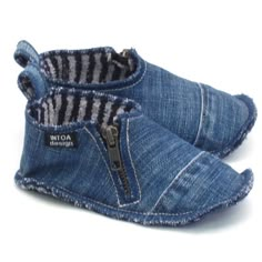 a pair of blue baby shoes with zippers on the bottom and side, both in denim