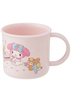 a pink coffee mug with cartoon characters on it