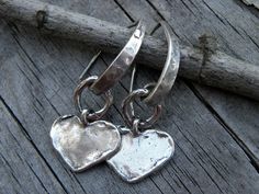 "Gorgeous solid handcrafted artisan sterling silver hearts and artisan sterling silver ear wires this one of a kind earrings are 1.5\" long. Rustic and modern they will make a statement! I have oxidized and polished the metal to a beautiful shine to bringing out all of the textures." Handmade Silver Double Heart Earrings, Silver Handmade Double Heart Earrings, Handmade Silver Heart Drop Earrings, Handmade Double Heart Sterling Silver Earrings, Handmade Silver Heart Pendant Earrings, Nickel-free Unique Heart Earrings, Unique Nickel-free Heart-shaped Earrings, Handmade Sterling Silver Heart Pendant Earrings, Handmade Heart-shaped Sterling Silver Earrings