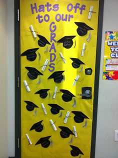 a door decorated with graduation caps and tassels that says hate's off to our graduates