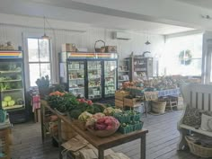 the inside of a grocery store filled with lots of fresh vegetables and fruits on display