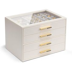 a white jewelry box with drawers and gold accents on the lid, open to reveal its contents