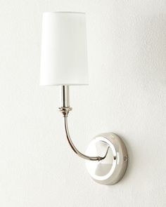 a wall light with a white shade on it