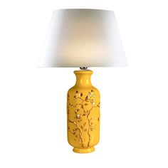 a yellow table lamp with a white shade on the top and gold flowers painted on it