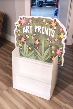 an art print is sitting on top of a cardboard box in the middle of a room