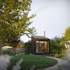 a small wooden structure sitting in the middle of a garden