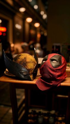 two hats sitting on top of a wooden table