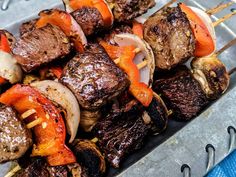 meat and vegetable kabobs on skewers ready to be served for consumption