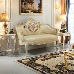 a living room with white furniture and gold accents on the walls, rugs and lamps