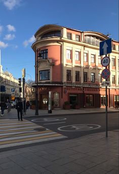 people crossing the street in front of a building