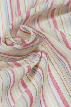 a close up view of a multicolored striped shirting material with small stripes