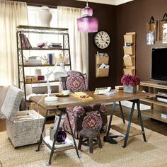 a living room filled with furniture and a flat screen tv on top of a wooden table