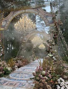 an elaborate garden with flowers and chandeliers