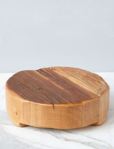 a wooden cutting board sitting on top of a white counter