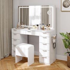 a white vanity with mirror and stool in front of a window next to a potted plant