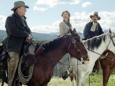 two men and a woman are riding horses