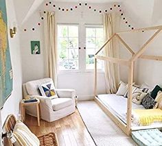 a bedroom with white walls and wooden floors