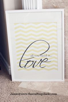 an art print with the words love in black and white on it next to a radiator