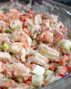 a bowl filled with shrimp salad on top of a table