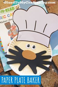 a paper plate with a chef's hat on it next to some children's books