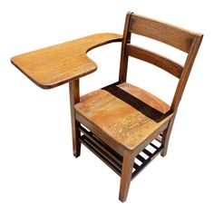 an old wooden chair with a desk attached to the backrest, on a white background