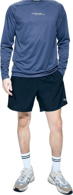 a man in shorts and socks standing with his hands on his hips