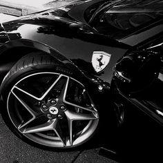 a black and white photo of a ferrari car