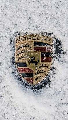 a porsche emblem is shown in the snow