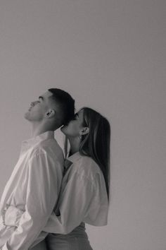 black and white photograph of man kissing woman's head with text overlay that reads, i love you