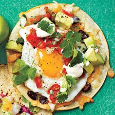 an egg is on top of some tortillas with other food items around it