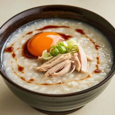 a bowl filled with rice, meat and an egg