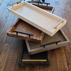 three wooden trays stacked on top of each other