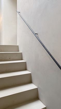 a set of white stairs leading up to a window