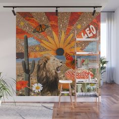 a wall mural with an image of a lion in front of a sunset and cactus