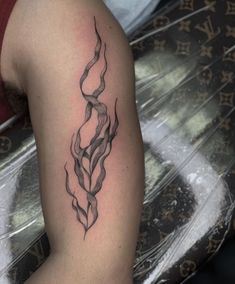 a woman's arm with a tattoo on it that looks like an abstract design