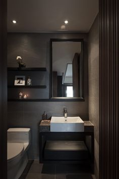 a bathroom with a toilet, sink and mirror in it's centerpieces