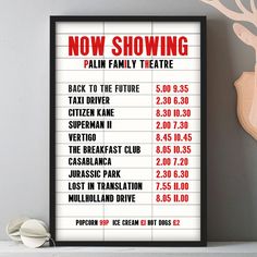 a poster with the words now showing palm family theatre in red and white on it