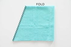 a piece of blue cloth with the word fold on it, and an image of a half