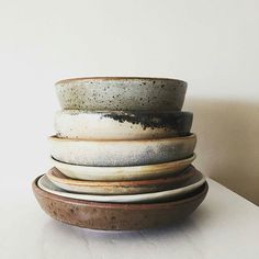 a stack of bowls sitting on top of a white table