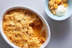 two bowls filled with food sitting on top of a white table next to each other