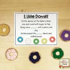 five little doughnuts are arranged on a wooden table with a sign that says 5 little donuts