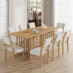 a wooden table with white chairs around it